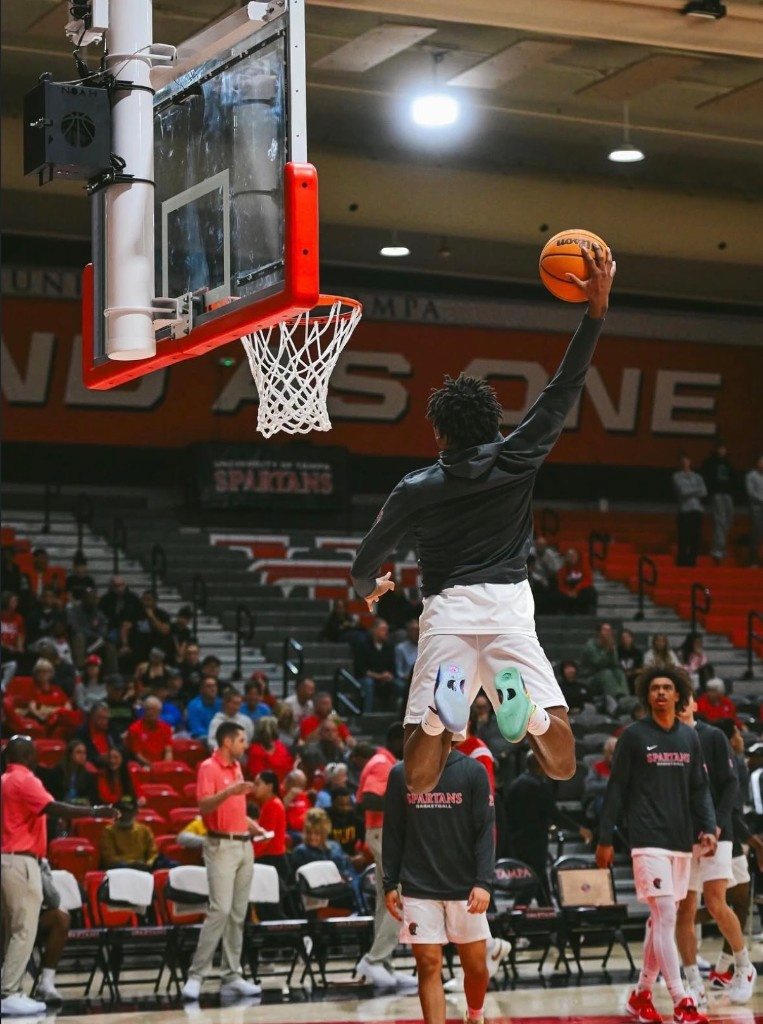 University of Tampa Spartans player rising for a dunk during warmups